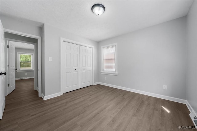7408 Newbys Ct, Chesterfield, VA 23832 - unfurnished bedroom featuring dark wood-type flooring, baseboards, and a closet