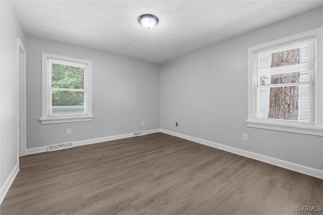 7408 Newbys Ct, Chesterfield, VA 23832 - spare room with dark wood-type flooring, baseboards, and a textured ceiling