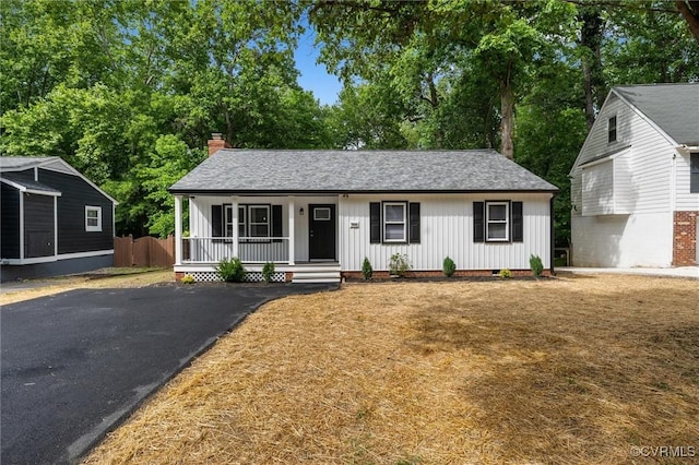7408 Newbys Ct, Chesterfield, VA 23832 - view of front of home with a porch, a chimney, board and batten siding, asphalt driveway, and a shingled roof