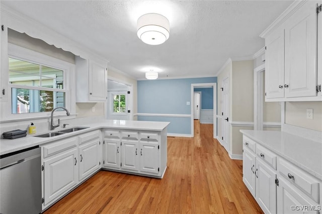2430 Olde Stone Rd, Midlothian, VA 23113 - kitchen with dishwasher, a sink, light countertops, white cabinets, and a peninsula