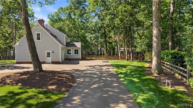 2430 Olde Stone Rd, Midlothian, VA 23113 - view of side of property featuring a chimney, driveway, and view of scattered trees