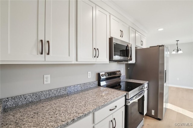 14057 Robinson Rd, Stony Creek, VA 23882 - kitchen featuring stainless steel appliances, white cabinetry, recessed lighting, light stone counters, and a chandelier