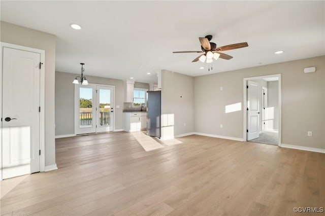 14057 Robinson Rd, Stony Creek, VA 23882 - unfurnished living room with a ceiling fan, a chandelier, light wood finished floors, baseboards, and recessed lighting