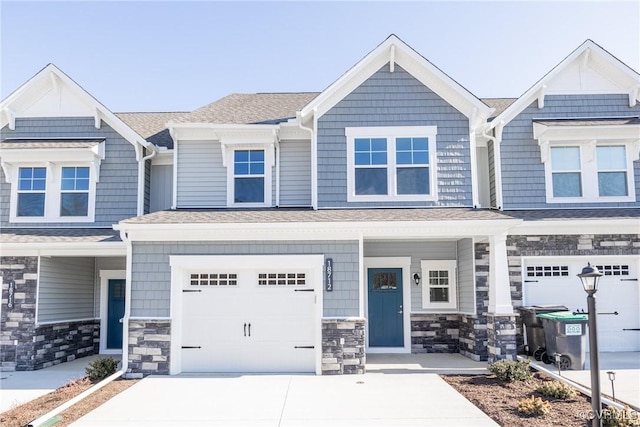 18732 Palisades Cove Trl, Moseley, VA 23120 - multi unit property with an attached garage, driveway, a porch, stone siding, and a shingled roof