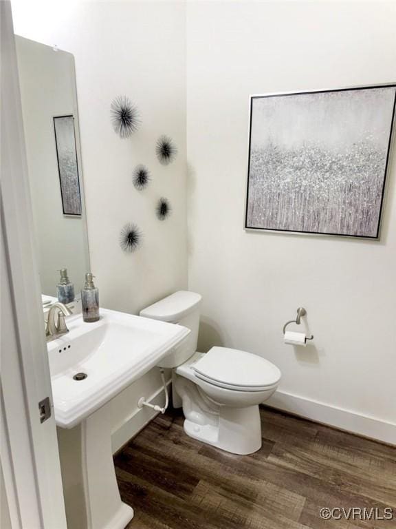 5112 Old Main St, Henrico, VA 23231 - half bathroom with wood finished floors, toilet, baseboards, and a sink