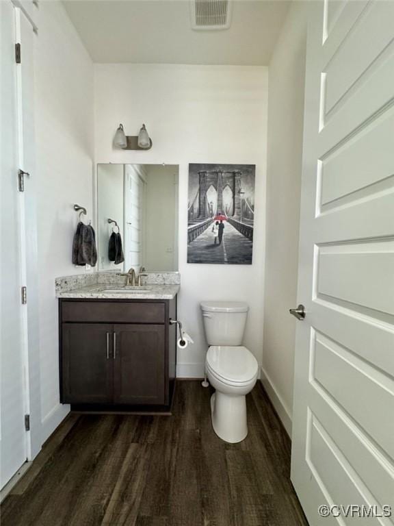 5112 Old Main St, Henrico, VA 23231 - bathroom with wood finished floors, toilet, vanity, and baseboards
