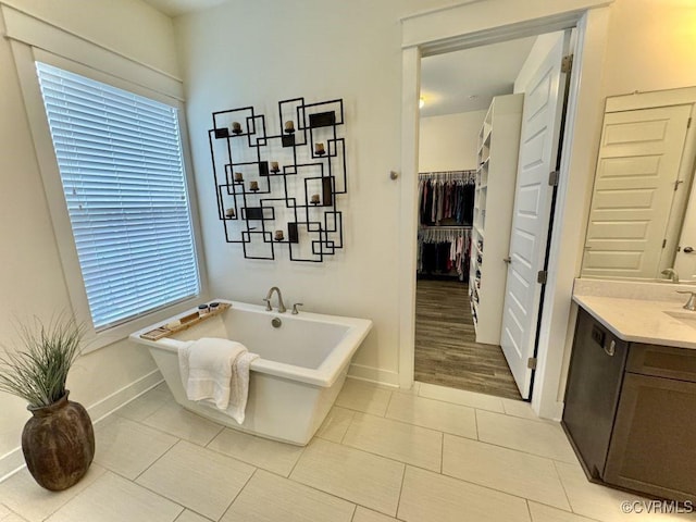 5112 Old Main St, Henrico, VA 23231 - full bathroom featuring a freestanding tub, tile patterned floors, vanity, baseboards, and a spacious closet