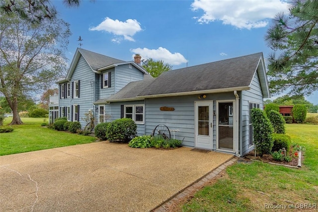 60 Edwards Landing Rd, Gwynn, VA 23066 - back of property featuring a chimney, a yard, and roof with shingles