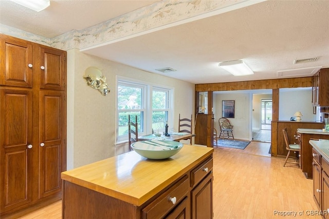 60 Edwards Landing Rd, Gwynn, VA 23066 - kitchen featuring butcher block counters, light wood finished floors, brown cabinets, and a center island