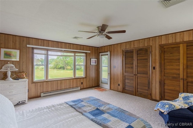 60 Edwards Landing Rd, Gwynn, VA 23066 - bedroom with a baseboard heating unit, carpet floors, wood walls, multiple closets, and ceiling fan