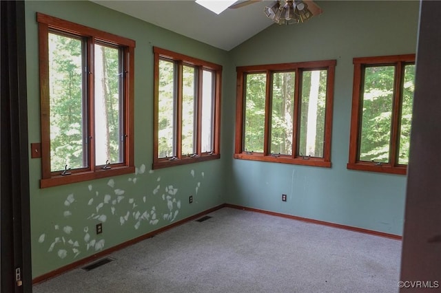 carpeted spare room featuring ceiling fan, lofted ceiling, and baseboards