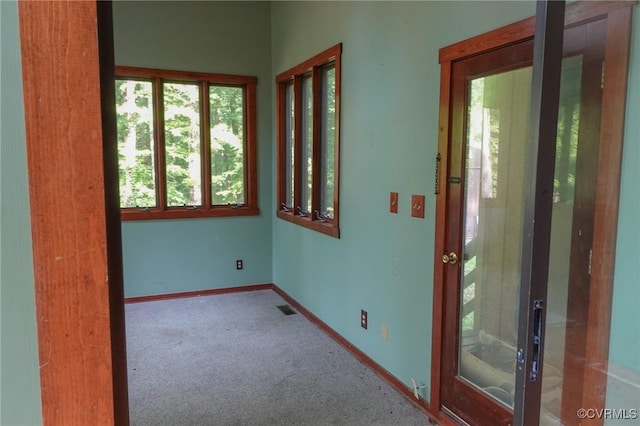 carpeted empty room with baseboards