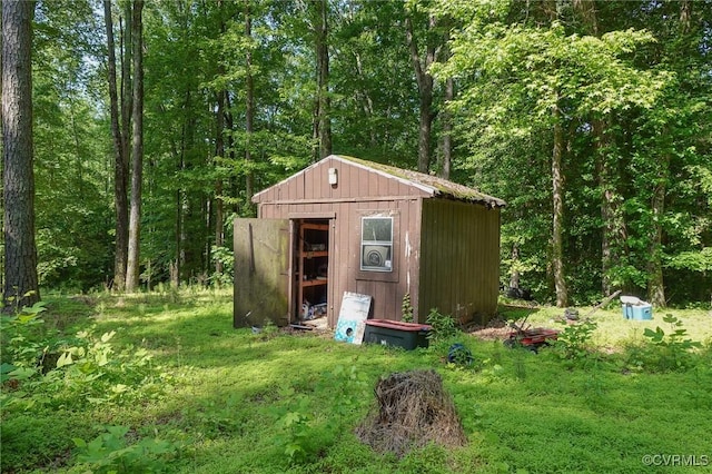 view of shed featuring a view of trees