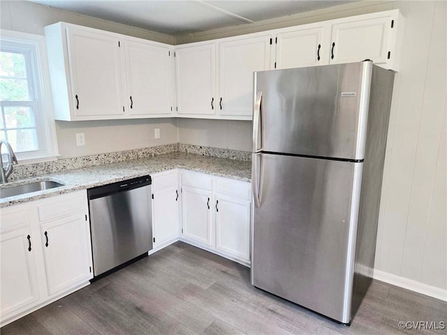 11400 Weyanoke Rd, Charles City, VA 23030 - kitchen with appliances with stainless steel finishes, wood finished floors, white cabinetry, and light stone countertops