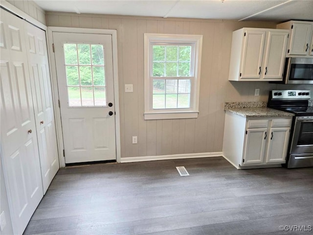 11400 Weyanoke Rd, Charles City, VA 23030 - kitchen with stainless steel appliances, dark wood finished floors, white cabinets, and light stone counters