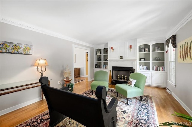 13951 Whitechapel Rd, Midlothian, VA 23113 - living area featuring light wood finished floors, baseboards, a fireplace, crown molding, and built in shelves