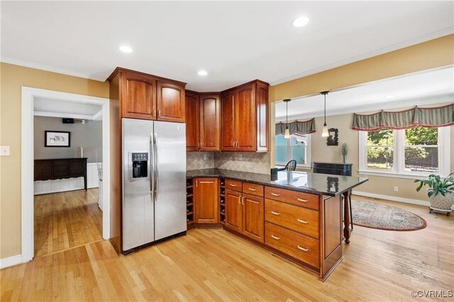 13951 Whitechapel Rd, Midlothian, VA 23113 - kitchen with stainless steel refrigerator with ice dispenser, light wood finished floors, baseboards, ornamental molding, and brown cabinets
