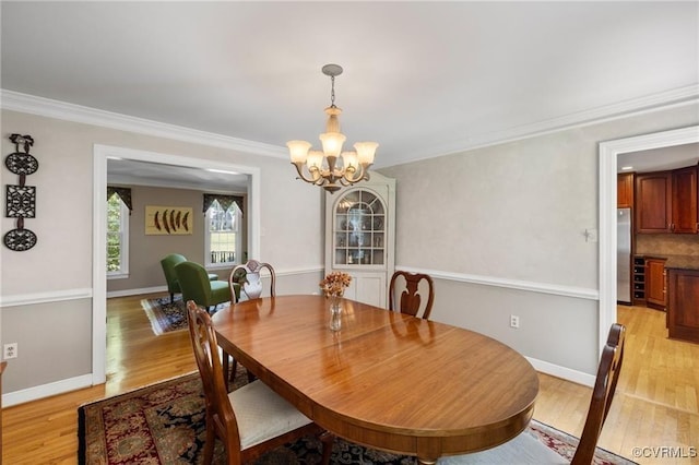 13951 Whitechapel Rd, Midlothian, VA 23113 - dining area featuring a chandelier, light wood-type flooring, crown molding, and baseboards