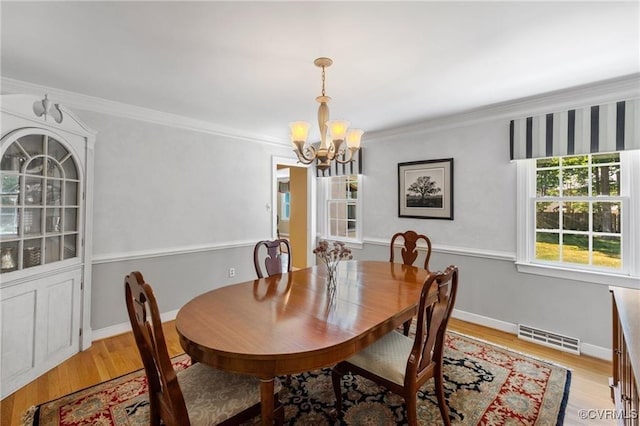 13951 Whitechapel Rd, Midlothian, VA 23113 - dining area with a chandelier, light wood-type flooring, crown molding, and baseboards