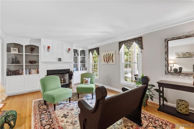 13951 Whitechapel Rd, Midlothian, VA 23113 - living area featuring light wood-style floors, a fireplace, ornamental molding, baseboards, and built in shelves