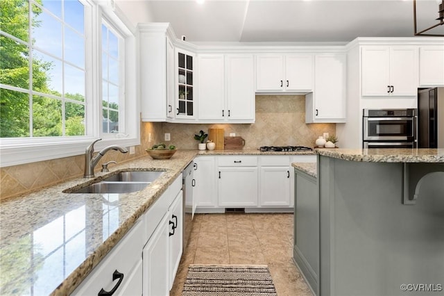 16400 Orchard Tavern Pl, Moseley, VA 23120 - kitchen with a sink, white cabinetry, gas stovetop, and glass insert cabinets