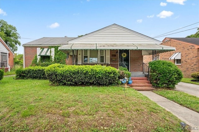 322 St Matthew St, Petersburg, VA 23803 - bungalow-style home with brick siding, a front lawn, and covered porch