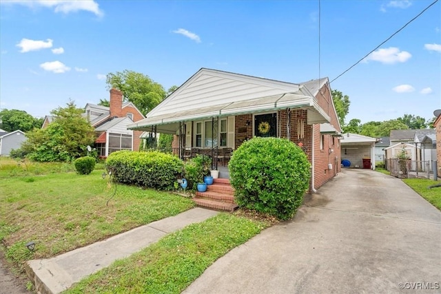 322 St Matthew St, Petersburg, VA 23803 - bungalow-style home with covered porch, brick siding, concrete driveway, and a carport
