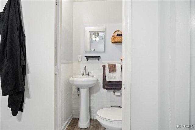 322 St Matthew St, Petersburg, VA 23803 - half bath with tile walls, toilet, wood finished floors, a wainscoted wall, and a sink