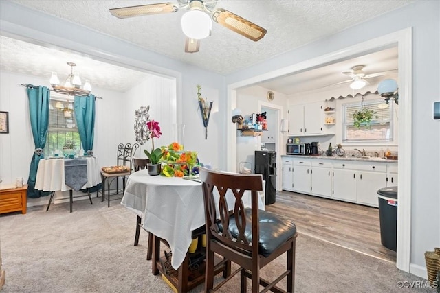 322 St Matthew St, Petersburg, VA 23803 - dining space featuring a textured ceiling, light colored carpet, a chandelier, and a ceiling fan