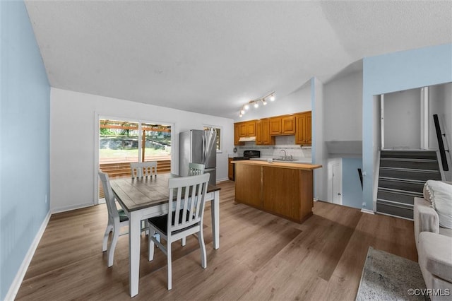 9120 Pepperidge Rd, Chesterfield, VA 23236 - dining area with rail lighting, vaulted ceiling, wood finished floors, stairs, and baseboards