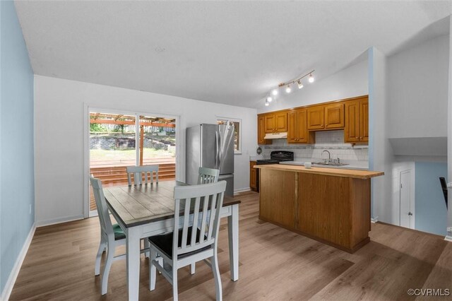 9120 Pepperidge Rd, Chesterfield, VA 23236 - kitchen with a sink, light countertops, decorative backsplash, freestanding refrigerator, and light wood-style flooring
