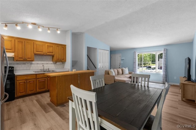 9120 Pepperidge Rd, Chesterfield, VA 23236 - dining area with light wood-style floors, a textured ceiling, vaulted ceiling, and stairway