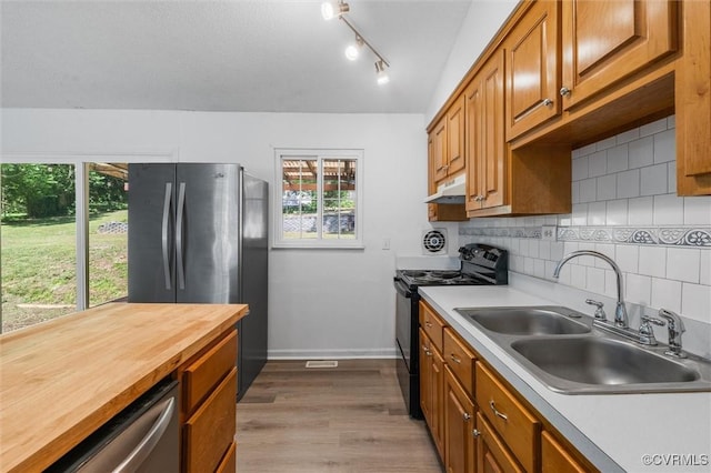 9120 Pepperidge Rd, Chesterfield, VA 23236 - kitchen with appliances with stainless steel finishes, a sink, wood counters, under cabinet range hood, and tasteful backsplash