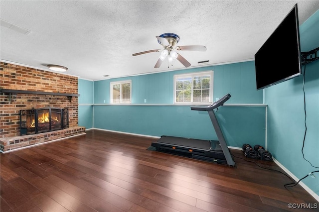 9120 Pepperidge Rd, Chesterfield, VA 23236 - workout room with a textured ceiling, wood-type flooring, a ceiling fan, a brick fireplace, and baseboards