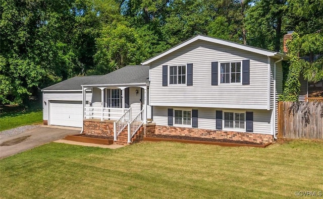 9120 Pepperidge Rd, Chesterfield, VA 23236 - tri-level home featuring brick siding, a porch, asphalt driveway, an attached garage, and view of scattered trees