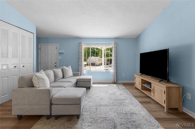 9120 Pepperidge Rd, Chesterfield, VA 23236 - living room with wood finished floors, a textured ceiling, and baseboards