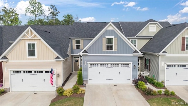 craftsman-style house featuring driveway, board and batten siding, and a shingled roof