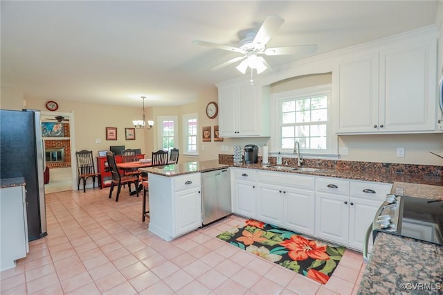 4606 Oak Hollow Rd, Chester, VA 23831 - kitchen featuring appliances with stainless steel finishes, a peninsula, a ceiling fan, white cabinetry, and a chandelier