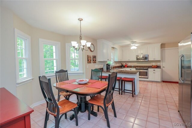 4606 Oak Hollow Rd, Chester, VA 23831 - dining room with a chandelier, light tile patterned flooring, and a ceiling fan