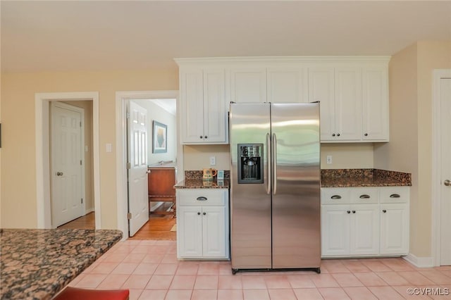 4606 Oak Hollow Rd, Chester, VA 23831 - kitchen featuring stainless steel fridge with ice dispenser, white cabinets, light tile patterned floors, and dark stone counters