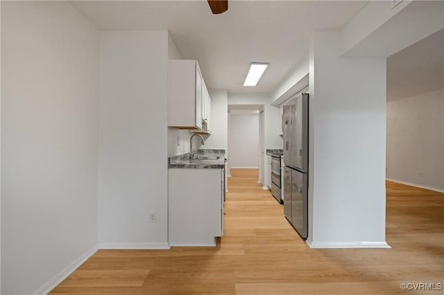 1503 Largo Rd Unit T3, Henrico, VA 23238 - kitchen with appliances with stainless steel finishes, white cabinetry, a sink, and light wood-style floors
