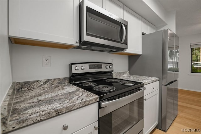 1503 Largo Rd Unit T3, Henrico, VA 23238 - kitchen featuring stainless steel appliances, light wood finished floors, white cabinetry, and light stone counters