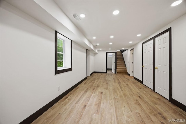 basement featuring recessed lighting, light wood finished floors, stairs, and baseboards