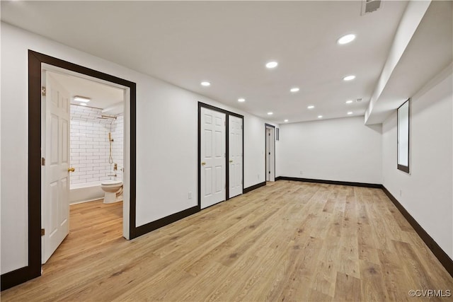 unfurnished room with light wood finished floors, recessed lighting, and baseboards