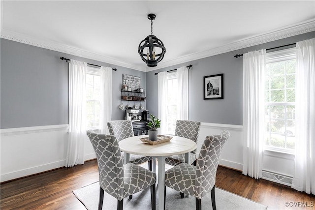 dining space with a chandelier, plenty of natural light, dark wood finished floors, crown molding, and baseboards