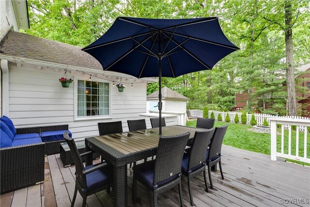 wooden deck with outdoor dining space and an outdoor hangout area