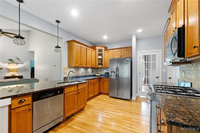 1845 Lower Mill Rd, Powhatan, VA 23139 - kitchen with appliances with stainless steel finishes, a sink, brown cabinets, tasteful backsplash, and recessed lighting