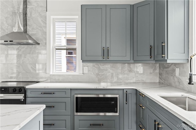 2001 Monteiro Ave, Richmond, VA 23222 - kitchen with wall chimney exhaust hood, stainless steel microwave, range with electric stovetop, backsplash, and light stone countertops