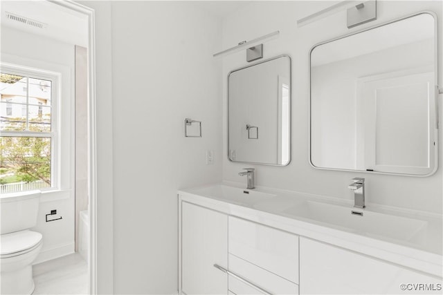 2001 Monteiro Ave, Richmond, VA 23222 - full bath with toilet, double vanity, and a tub to relax in