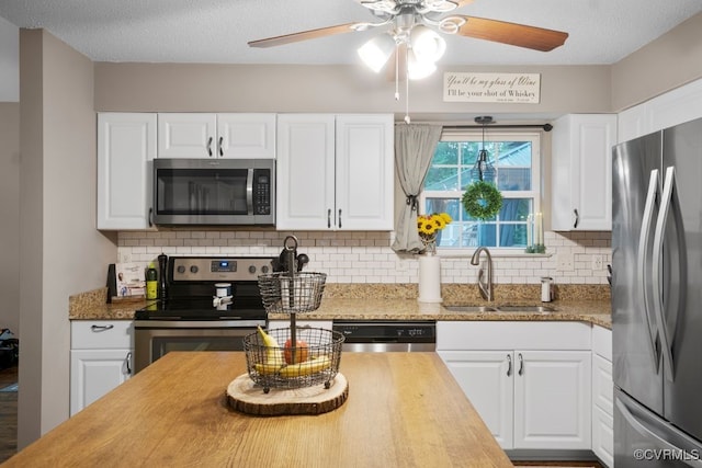 3190 Magnolia Woods Ter, New Kent, VA 23141 - kitchen with appliances with stainless steel finishes, a sink, a ceiling fan, and white cabinets